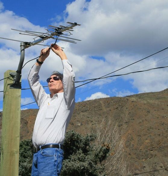 Sandy (technician-retired) helping with an area resident's television antenna